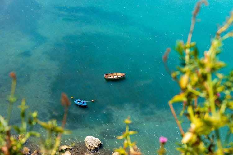 Idyllisk udsigt over Agropolihavnen i Cilento med farverige både og turkisblåt vand - perfekt destination for din sommerferie i Italien