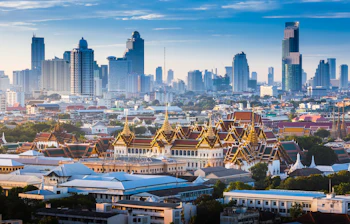 Bangkok skyline med Det Store Palads og moderne skyskrabere ved solnedgang