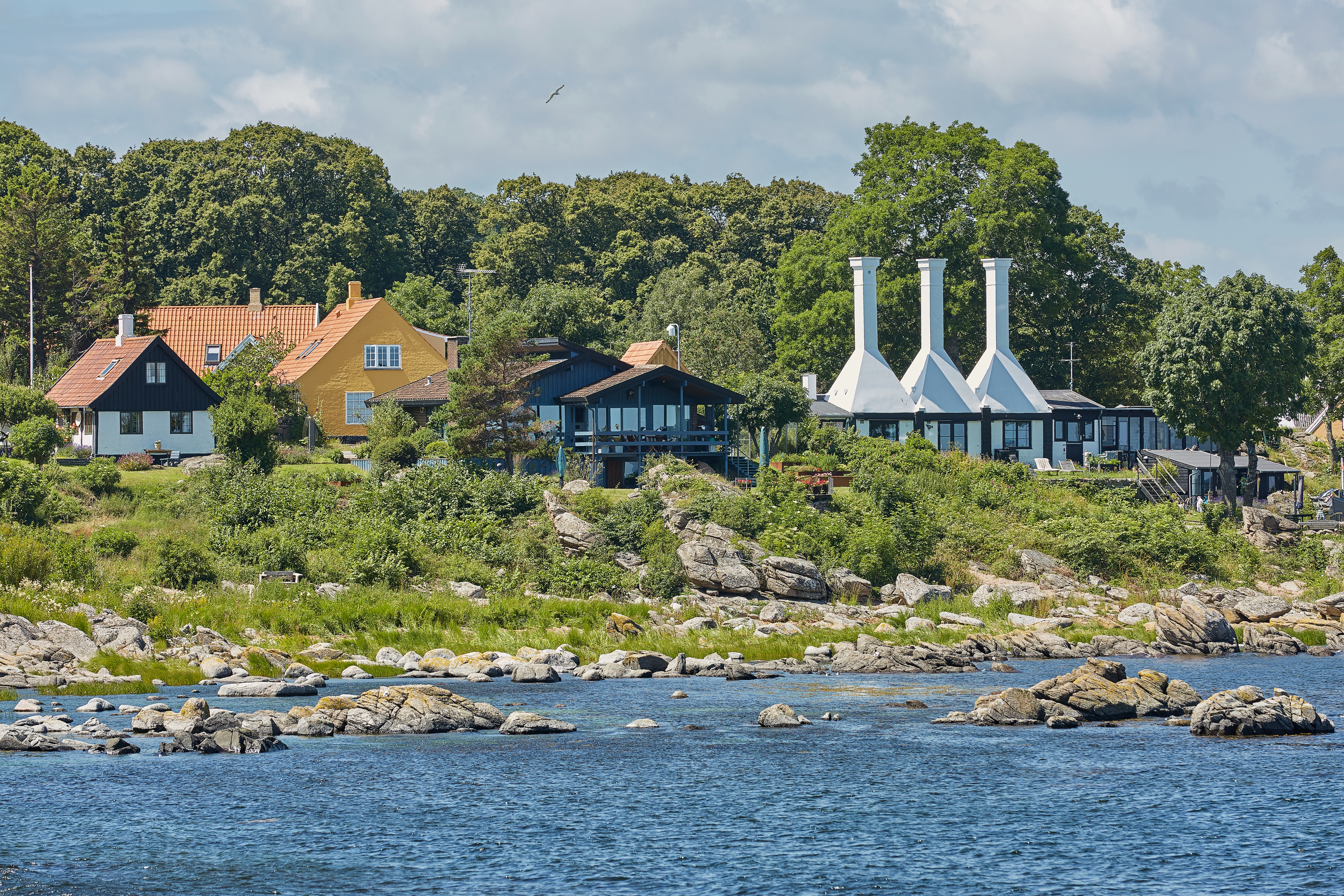 Karakteristiske røgerier med deres specielle skorstene i den charmerende by Svaneke på Bornholm, hvor den lokale tradition for røgning af fisk stadig holdes i hævd og tiltrækker madinteresserede turister året rundt