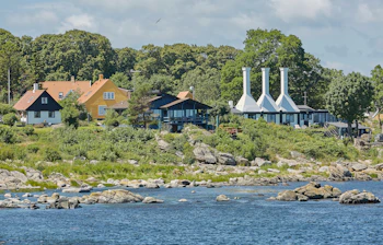 Karakteristiske røgerier med deres specielle skorstene i den charmerende by Svaneke på Bornholm, hvor den lokale tradition for røgning af fisk stadig holdes i hævd og tiltrækker madinteresserede turister året rundt