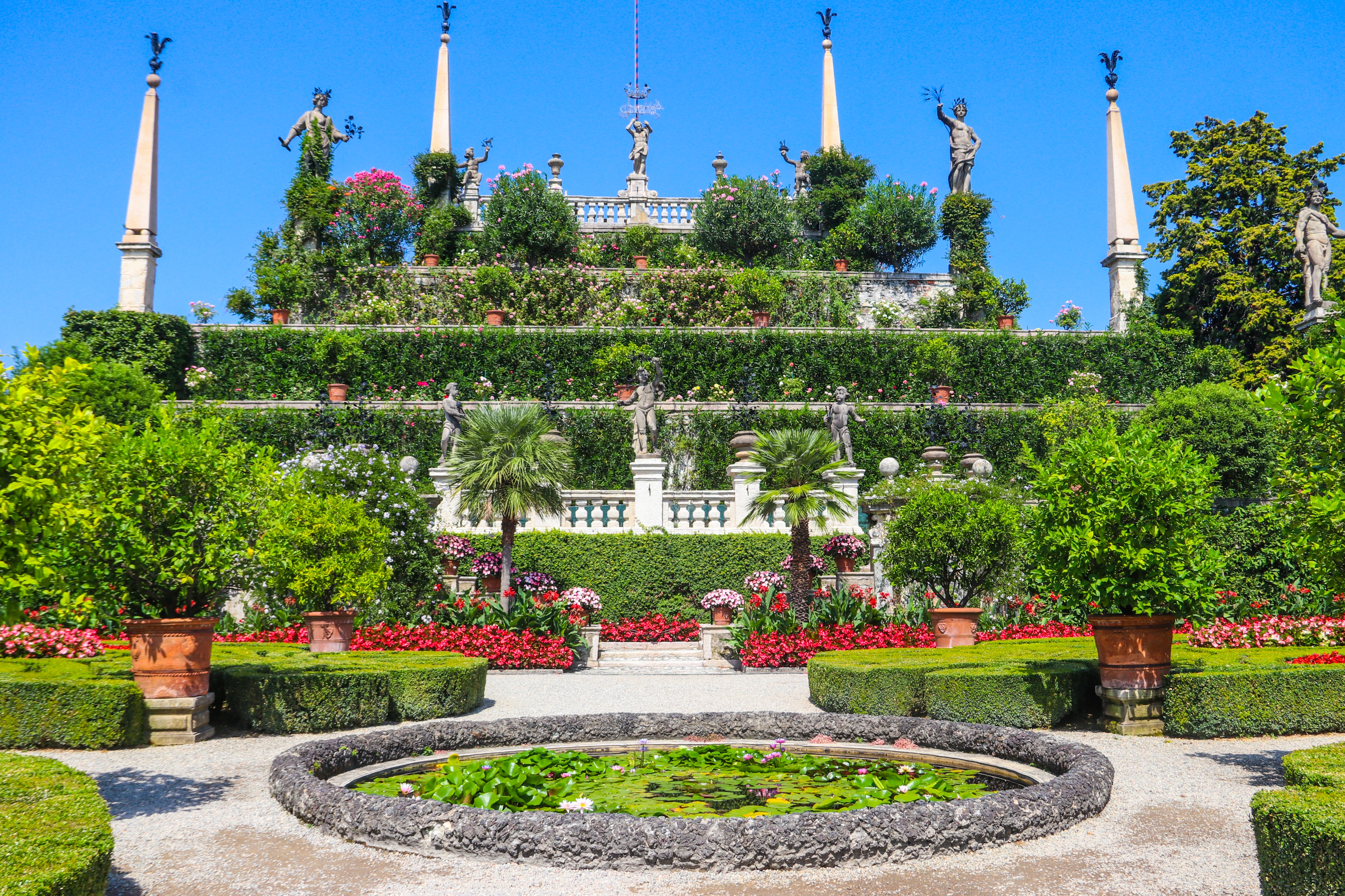 Stunning baroque terraced gardens of Borromeo Palace with fountains and sculptures overlooking Lake Maggiore at Isola Bella, Stresa, Italy