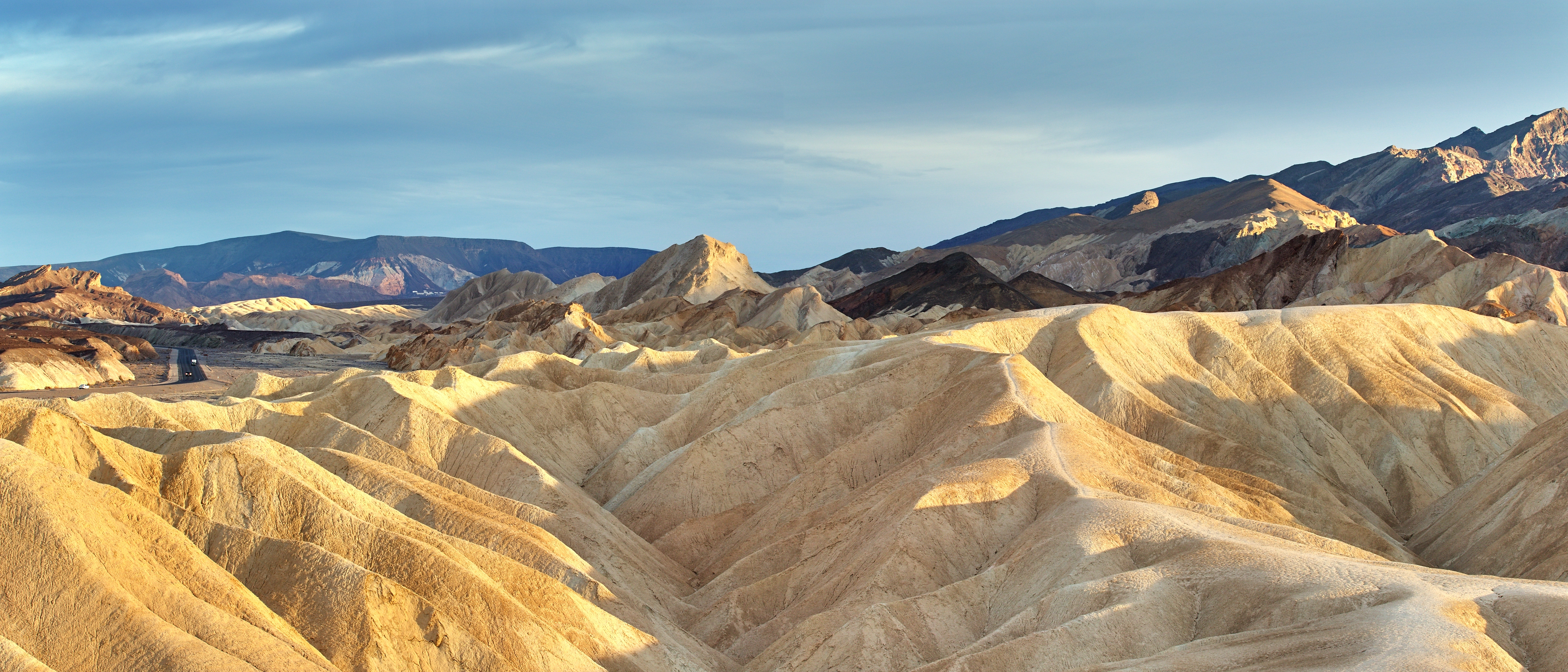 Gylden solnedgang over Death Valley ørkenbjerge og badlands i Californien