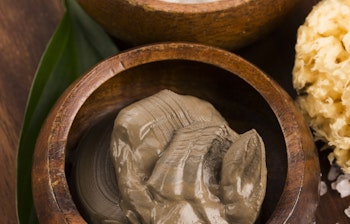 Naturligt Dødehavs-mudder og salt i træskåle, kendt for deres unikke mineraler og hudplejende egenskaber fra Israel og Jordan