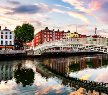 Den ikoniske Ha'penny Bridge oplyst om aftenen i Dublin - et højdepunkt på vores 8-dages rundrejse gennem fortryllende Irland