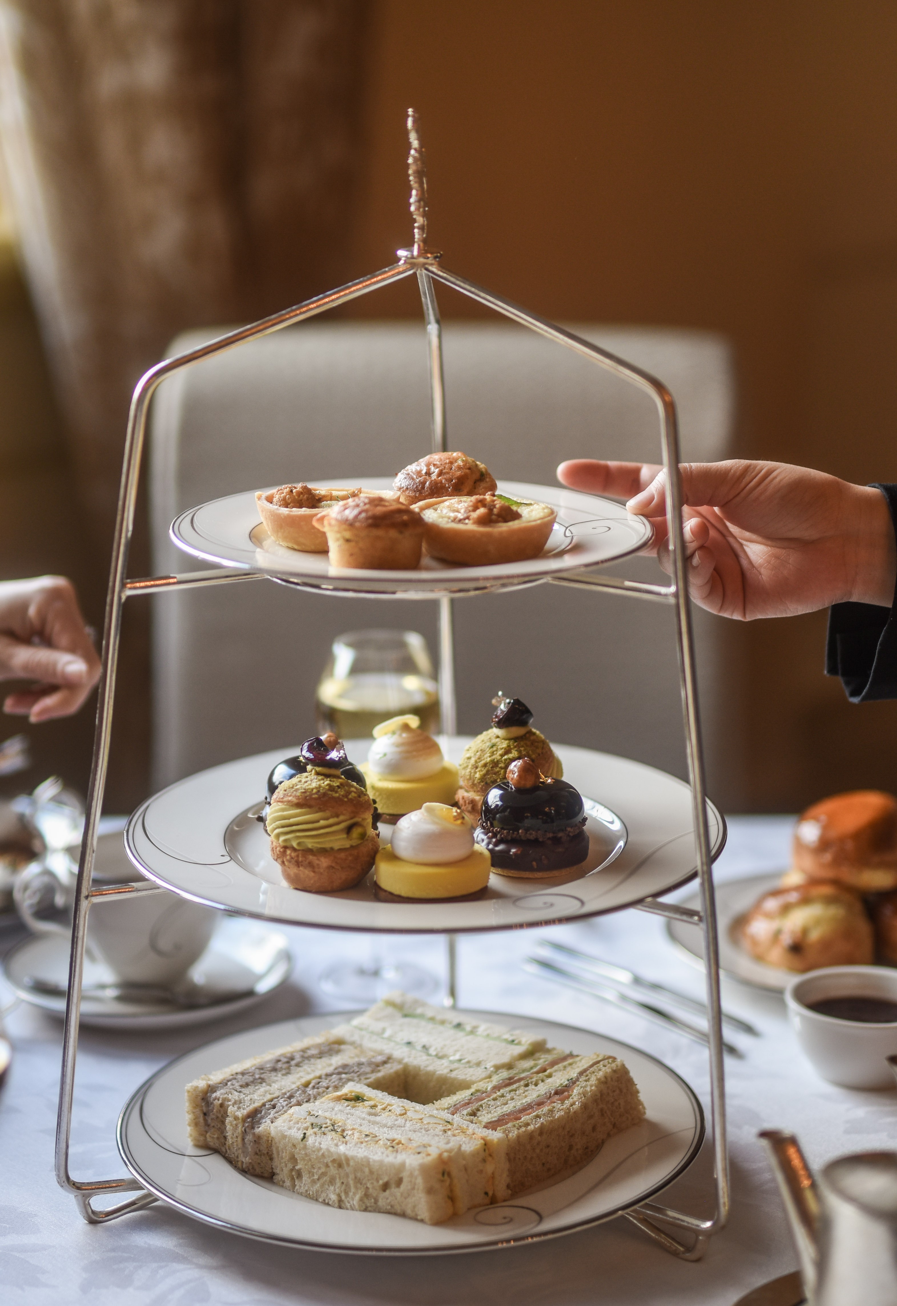 Elegant eftermiddags te med etagefad fyldt med finger sandwiches, kager og søde sager