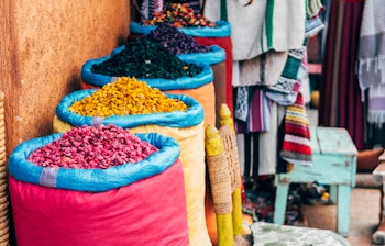 Farverige krydderisække på et traditionelt marked i Marrakech, Marokko - en sanselig oplevelse på rejsen til Nordafrika