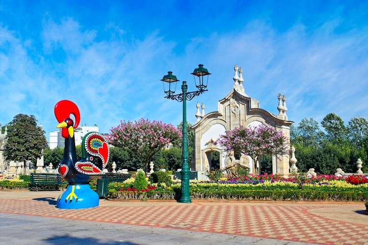 Den farverige Barcelos-hane (Galo de Barcelos), et berømt portugisisk kultursymbol, der pryder en have i Barcelos på vandreferie i Nordportugal