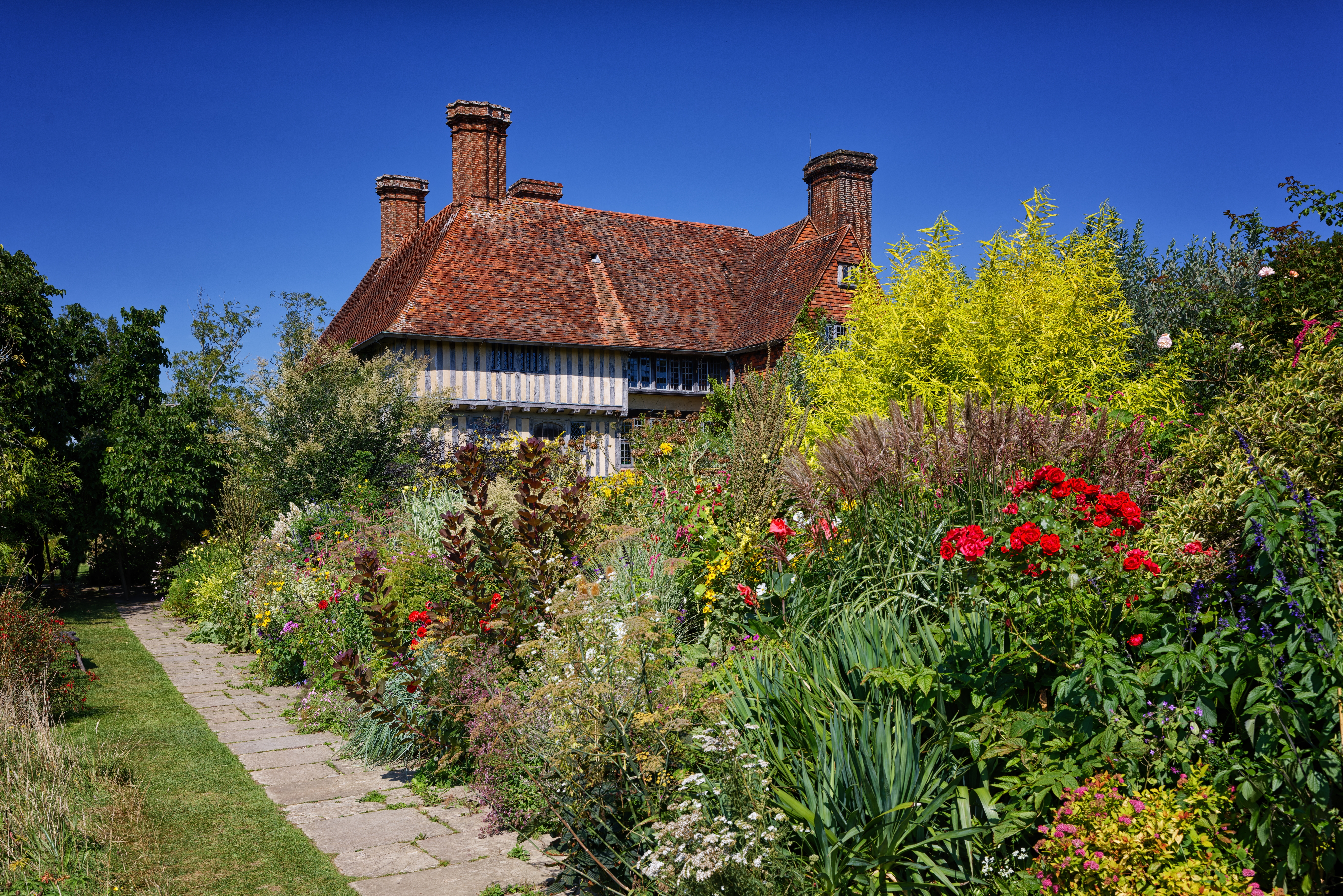 Great Dixter House and Gardens i Northiam, East Sussex med farverige blomsterbede og traditionel Tudor-arkitektur