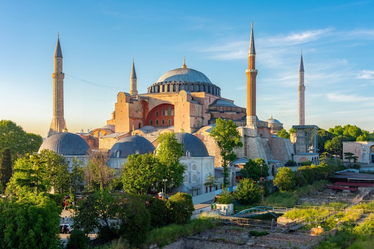 Den historiske Hagia Sophia Grand Moske med dens ikoniske kuppel og minareter ved solnedgang i Istanbul, Tyrkiet