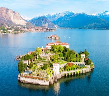Luftpanorama af Isola Bella med Borromeo-slottet og Stresa by ved Lago Maggiore i Norditalien omgivet af Alperne