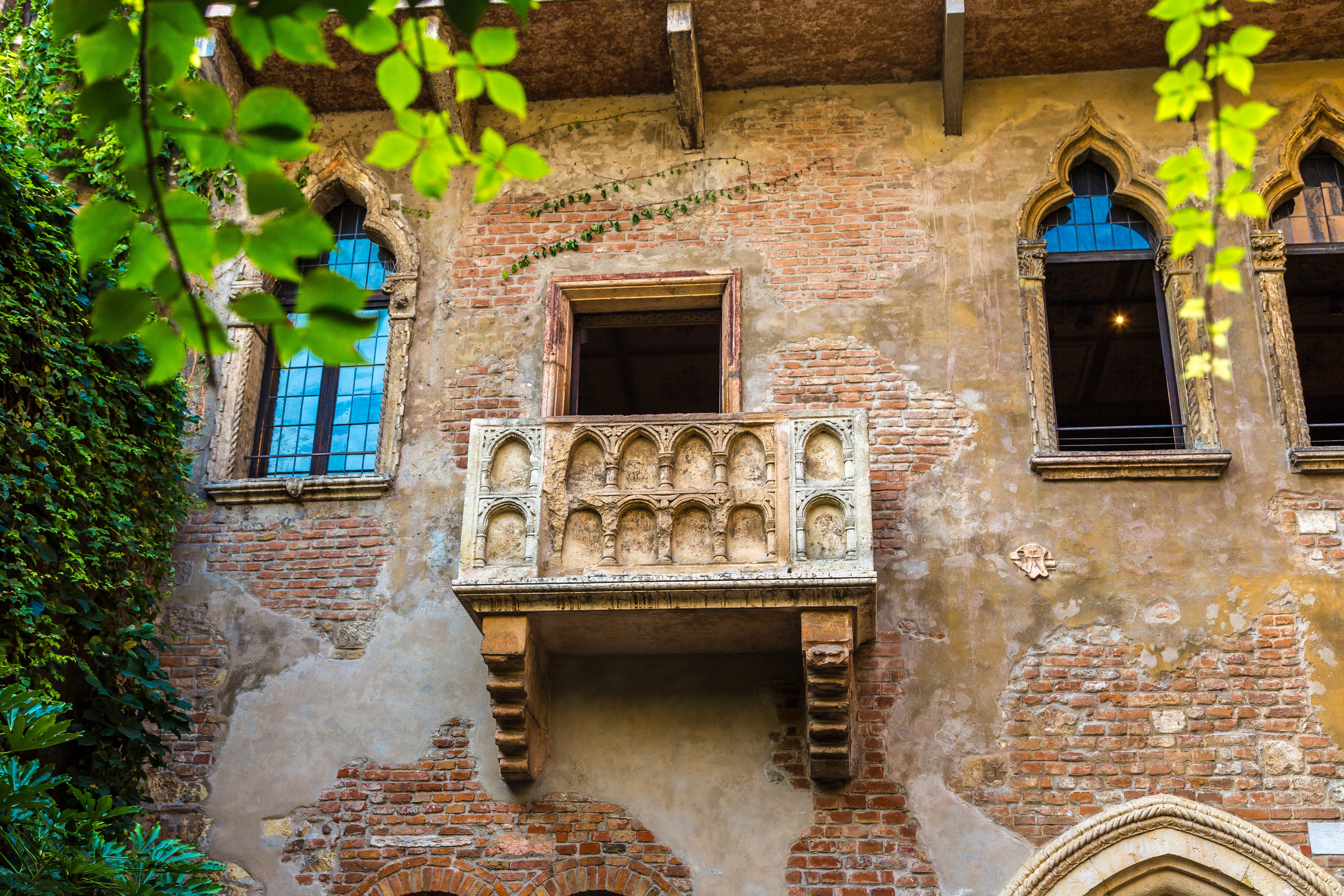 Den historiske Romeo og Julie balkon i Verona - det romantiske middelalderhus Casa di Giulietta med den ikoniske stenbygning fra Shakespeares tragedie