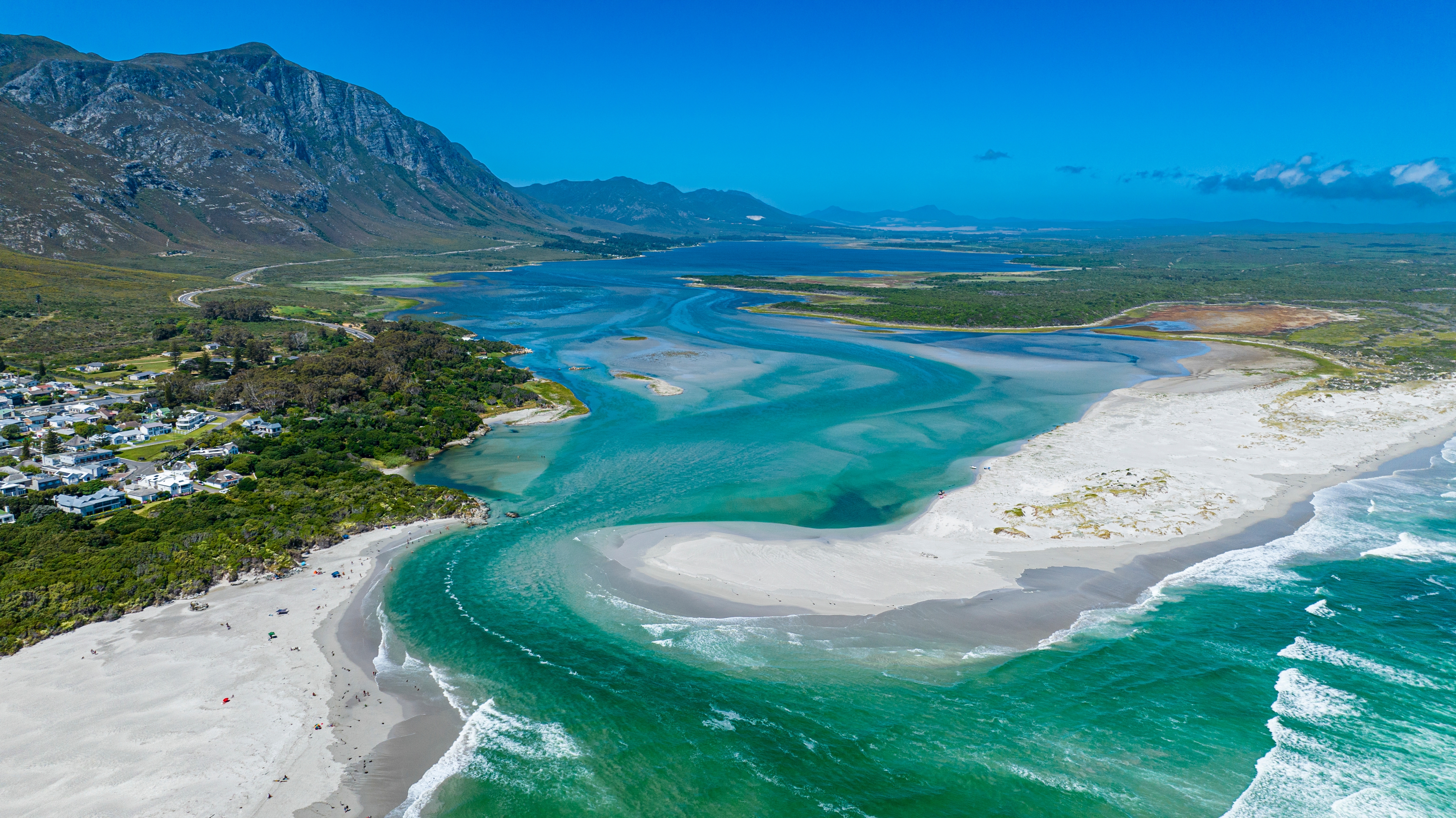 Betagende luftfoto af Klein River-lagunen der møder havet ved Hermanus i Western Cape-provinsen, Sydafrika