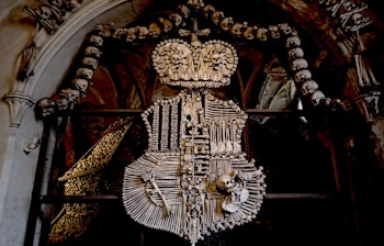 Knoglekapel med menneske kranier og knogler arrangeret i dekorative mønstre som religiøs kunst