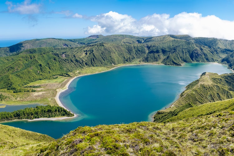 Betagende panoramaudsigt over Lagoa do Fogo (Ildsøen), en smuk blå kratersø omgivet af frodige grønne bjerge på São Miguel, Azorerne