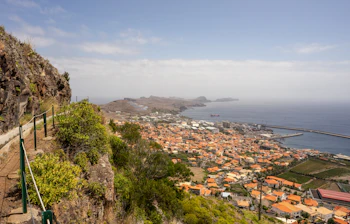 Betagende udsigt over Levada do Canical vandreruten på Madeira med grønne bjerge og blå himmel, perfekt til vandreferie i Portugal