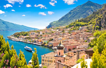 Smukt panoramaudsigt over Limone sul Garda med turkisblåt vand, farverige bygninger og grønne bjerge ved Gardasøen i Lombardiet, Italien