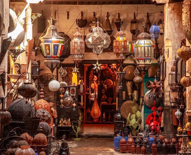 Farverig butik med traditionelle marokkanske lamper og lanterner med dekorativt metalarbejde og farvet glas i den livlige souk-markedsplads i Marrakech, Marokko