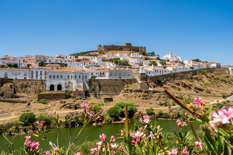 Historisk hvid landsby Mertola med gammelt slot ved Guadiana floden i Portugal