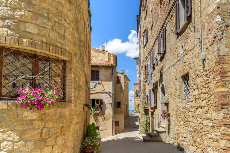 Charmerende smal gade med historiske stenhuse i den middelalderlige by Volterra, Toscana - en af perlerne på vores rejse