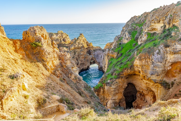 Gyldenbrune kalkstensklipper og turkisblåt vand ved Ponta da Piedade nær Lagos i Algarve, Portugal - et højdepunkt på vandreferie langs Algarvekysten
