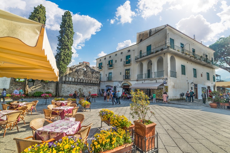 Domkirkepladsen i Ravello med udendørs caféer under en skyet himmel, en charmerende bjergby 350 meter over havet på Amalfikysten i Italien