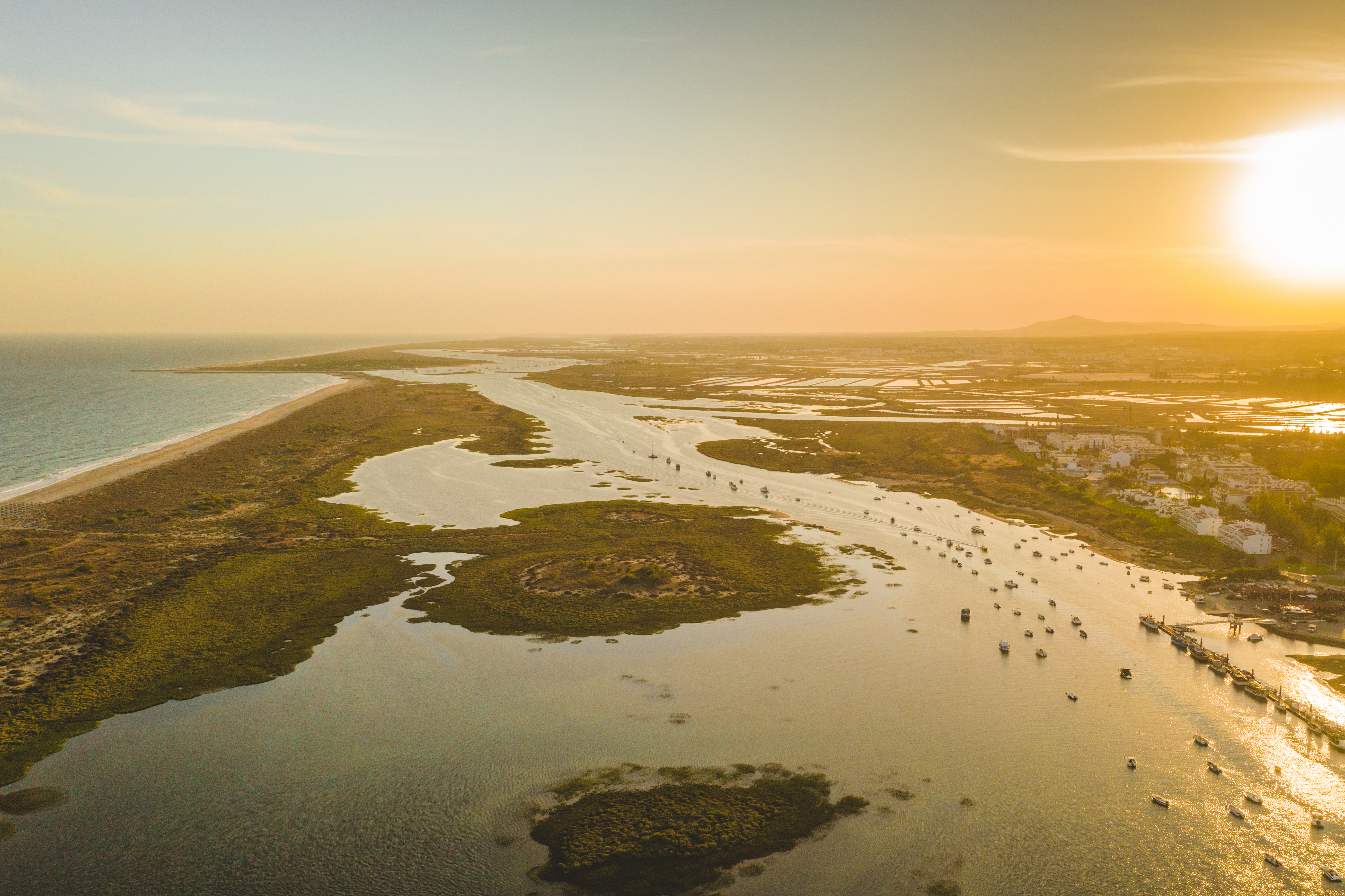 Flot solnedgang over Ria Formosa lagune med både og sandbanker i Algarve Portugal