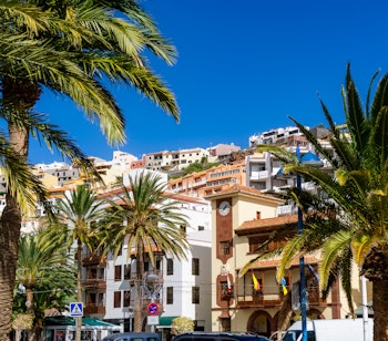 Malerisk udsigt over hovedstaden San Sebastián med farverige bygninger og palmer på den kanariske ø La Gomera