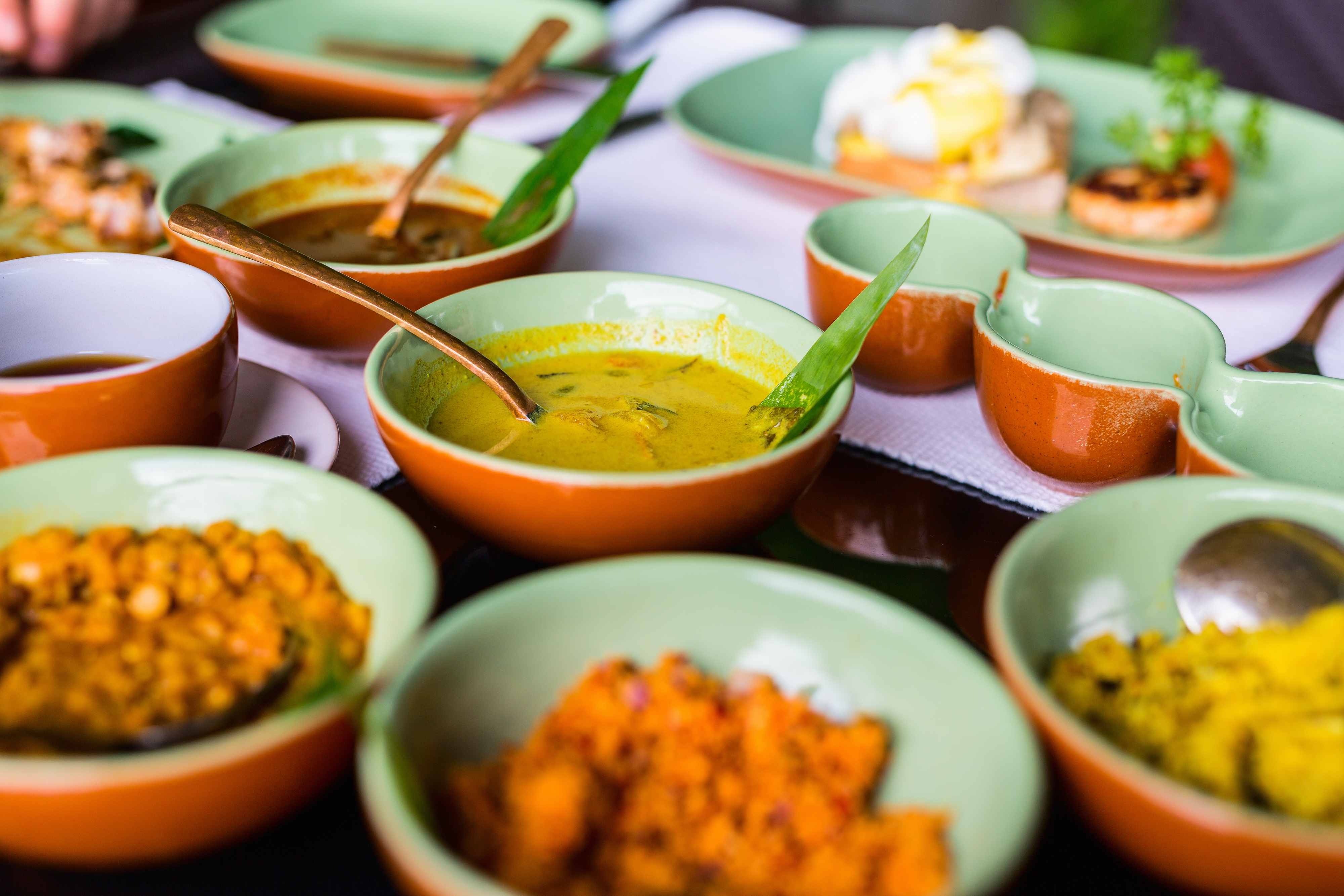 Farverige traditionelle curry-retter fra Sri Lanka serveret i skåle, der viser landets autentiske madkultur