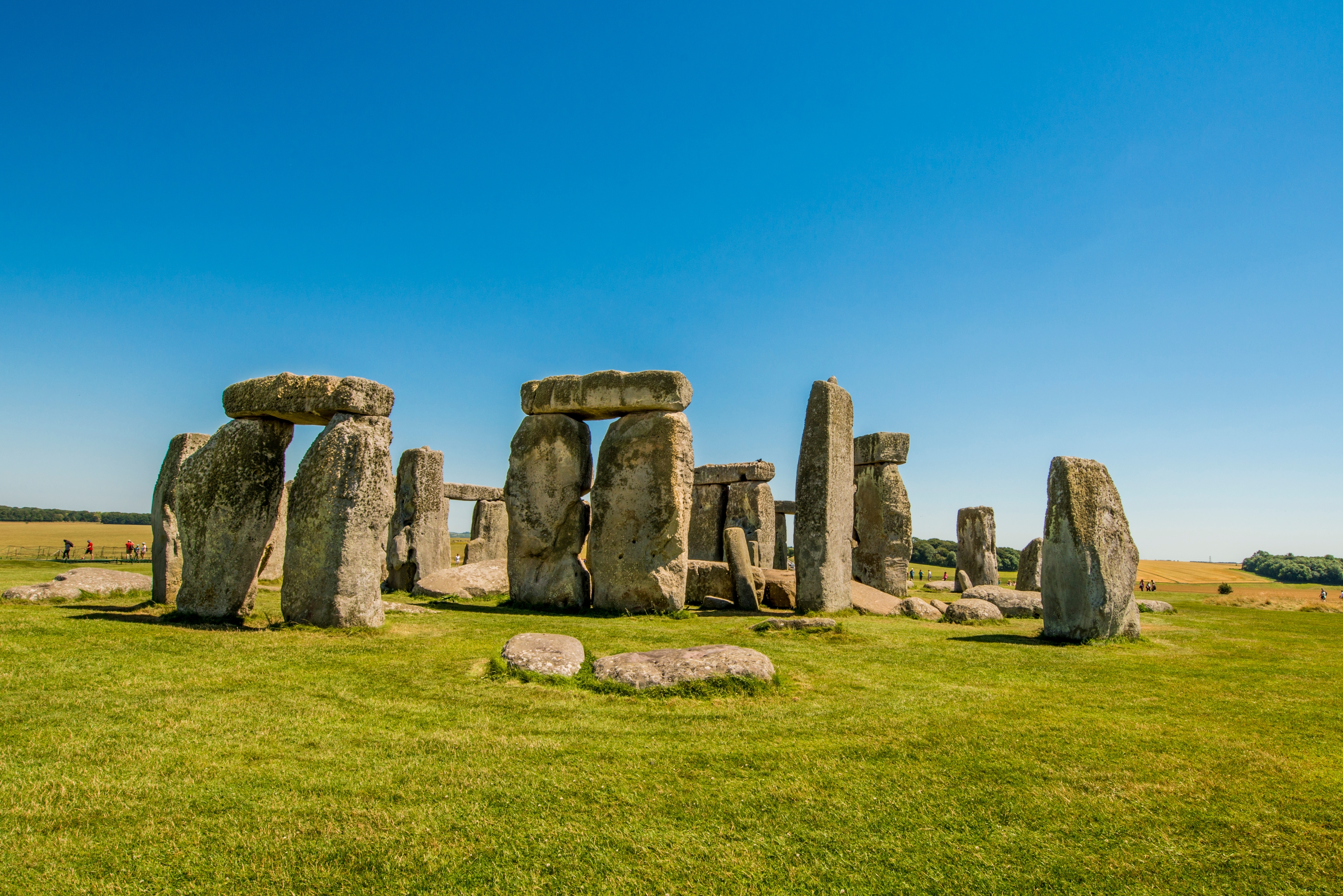 Stonehenge stenmonument på Salisbury Plain England med grønt græs og blå himmel