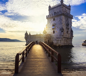 Torre de Belem - det berømte historiske vartegn ved Tagus-floden i Lissabon, Portugal, oplyst i solnedgangen