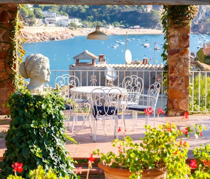 Panoramaudsigt over Tossa de Mar med middelalderslot, turkisblåt hav og sandstrand ved Costa Brava i Spanien
