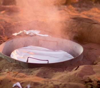 Autentisk beduin-middag serveret i telt i Wadi Rum-ørkenen i Jordan med traditionelle retter på bordet