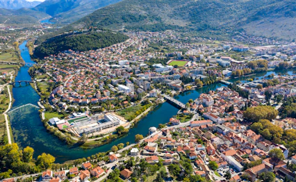 Luftfoto af Trebinje historiske bycenter med Trebisnjica-floden og bjerge i Bosnien-Hercegovina