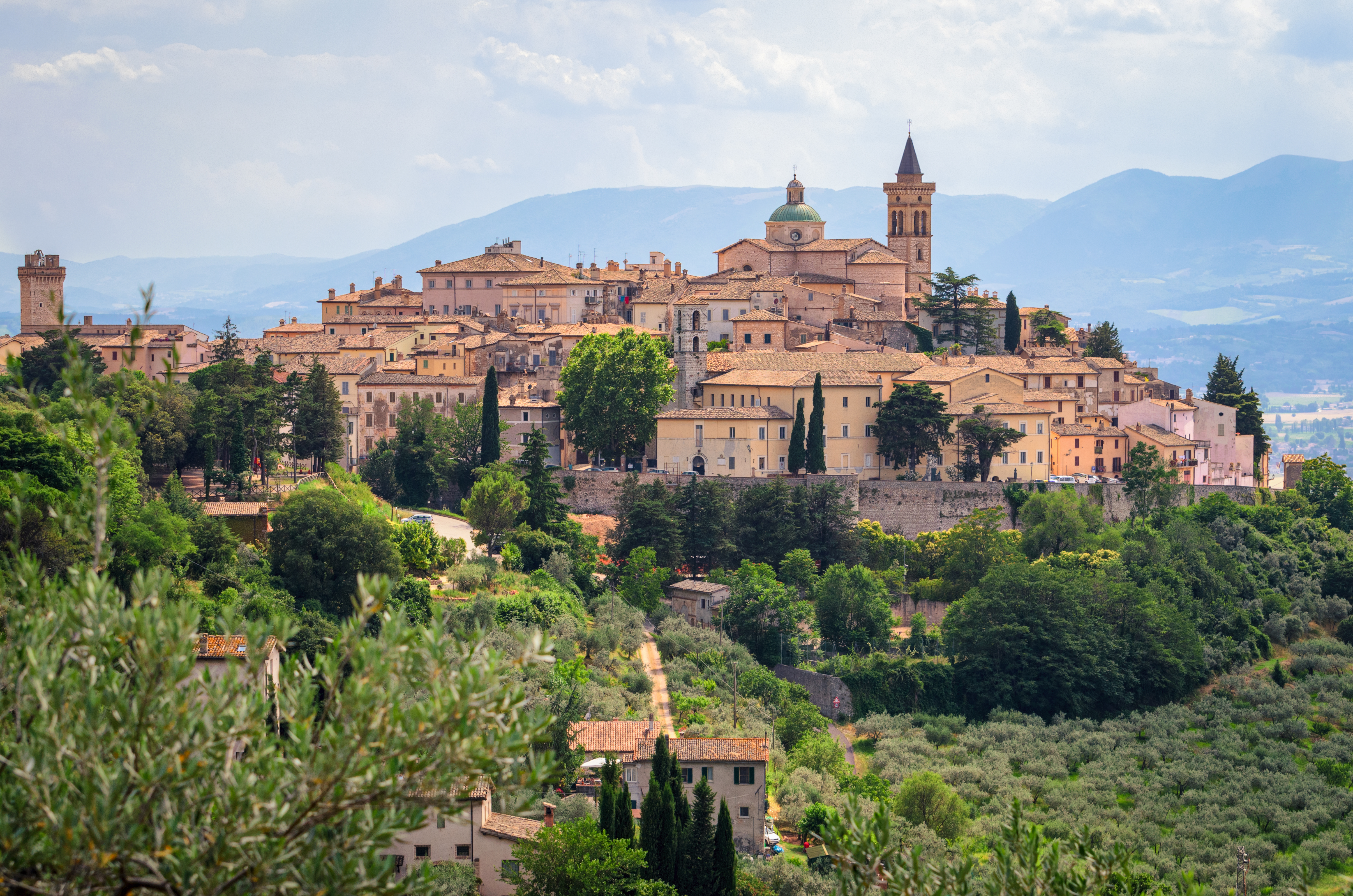 Middelalderlig bjergby Trevi i Umbria Italien med gamle stenbygninger og kirketårne omgivet af grøn natur