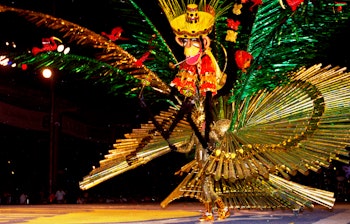 Farvestrålende karneval i Port of Spain på Trinidad med dansere i ekstravagante fjerkostumer og livlig calypsomusik