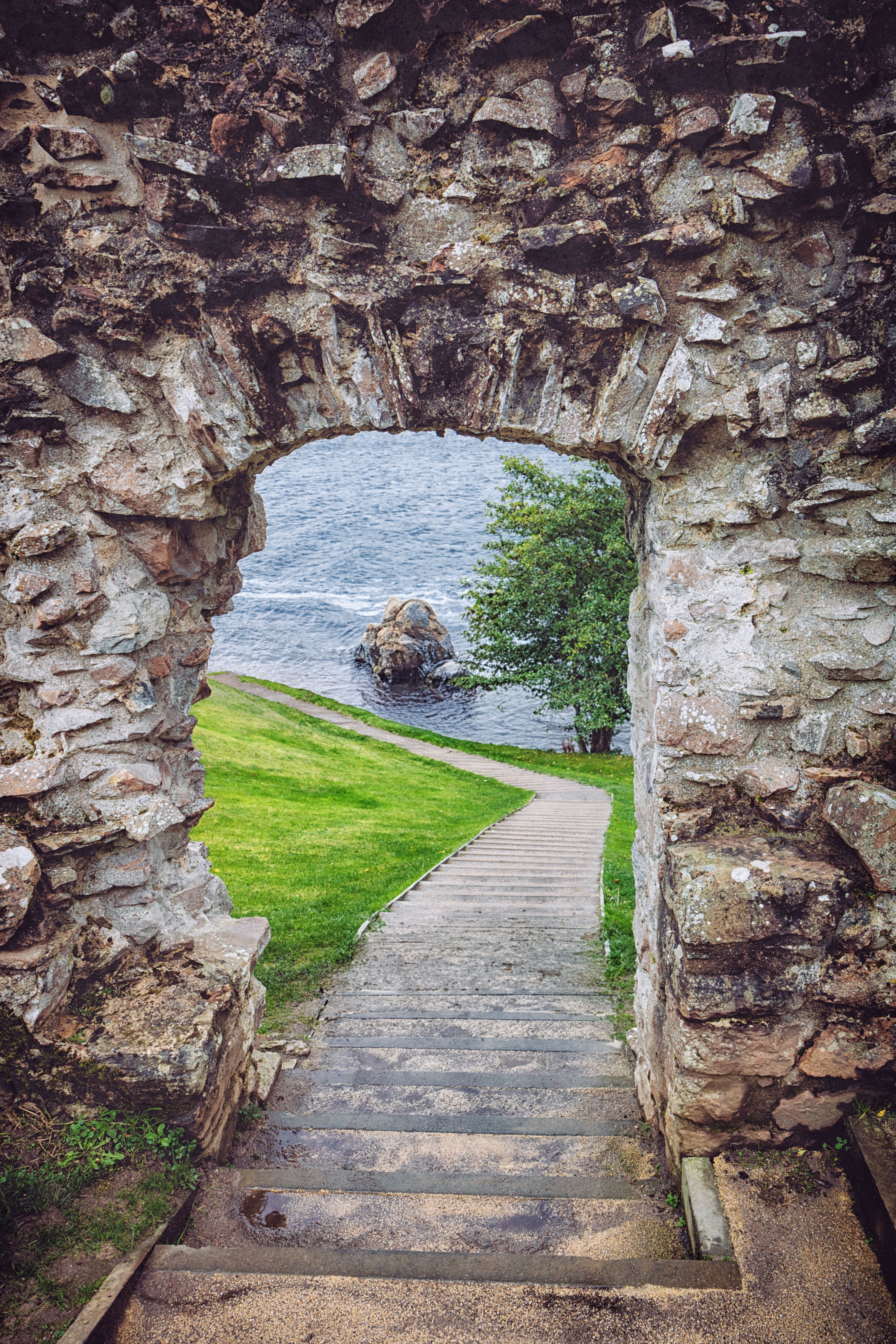 Historisk stenbue i ruinerne af Urquhart Castle med udsigt over det mytiske Loch Ness i det skotske højland, et højdepunkt på rundrejsen i Sagnomspundne Skotland
