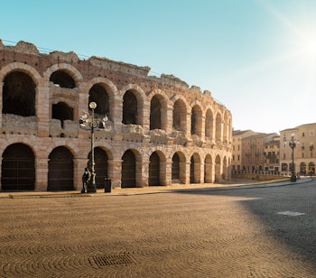 Den historiske Arena di Verona, et velbevarede romersk amfiteater fra antikken, badet i gyldent sollys på Piazza Bra i Norditalien